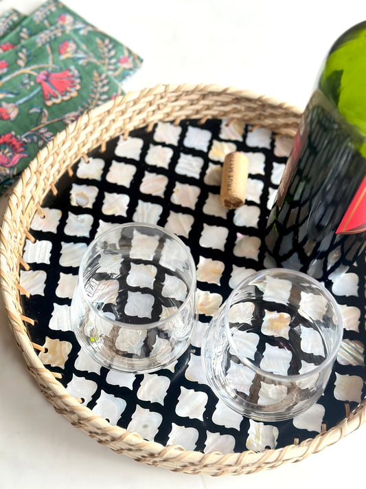 stunning mother of pearl and rattan serving tray containing wine glasses and a wine bottle