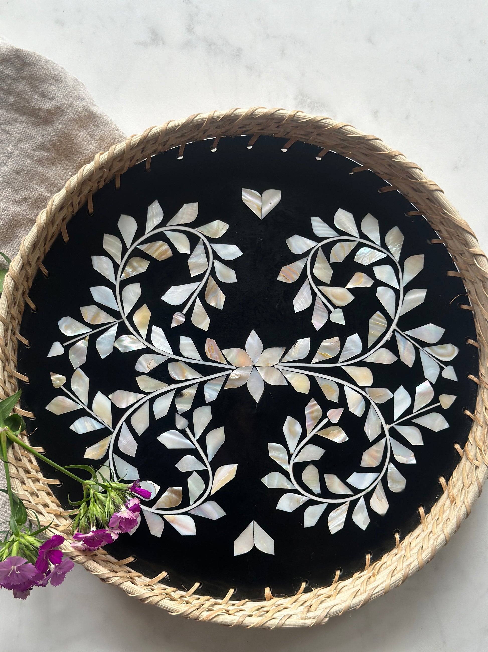 large mother of pearl inlay tray with a floral design and rattan woven edges