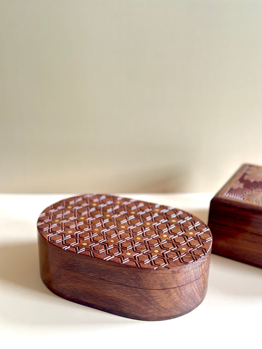 oval hand-carved wooden box with star motifs and gold work