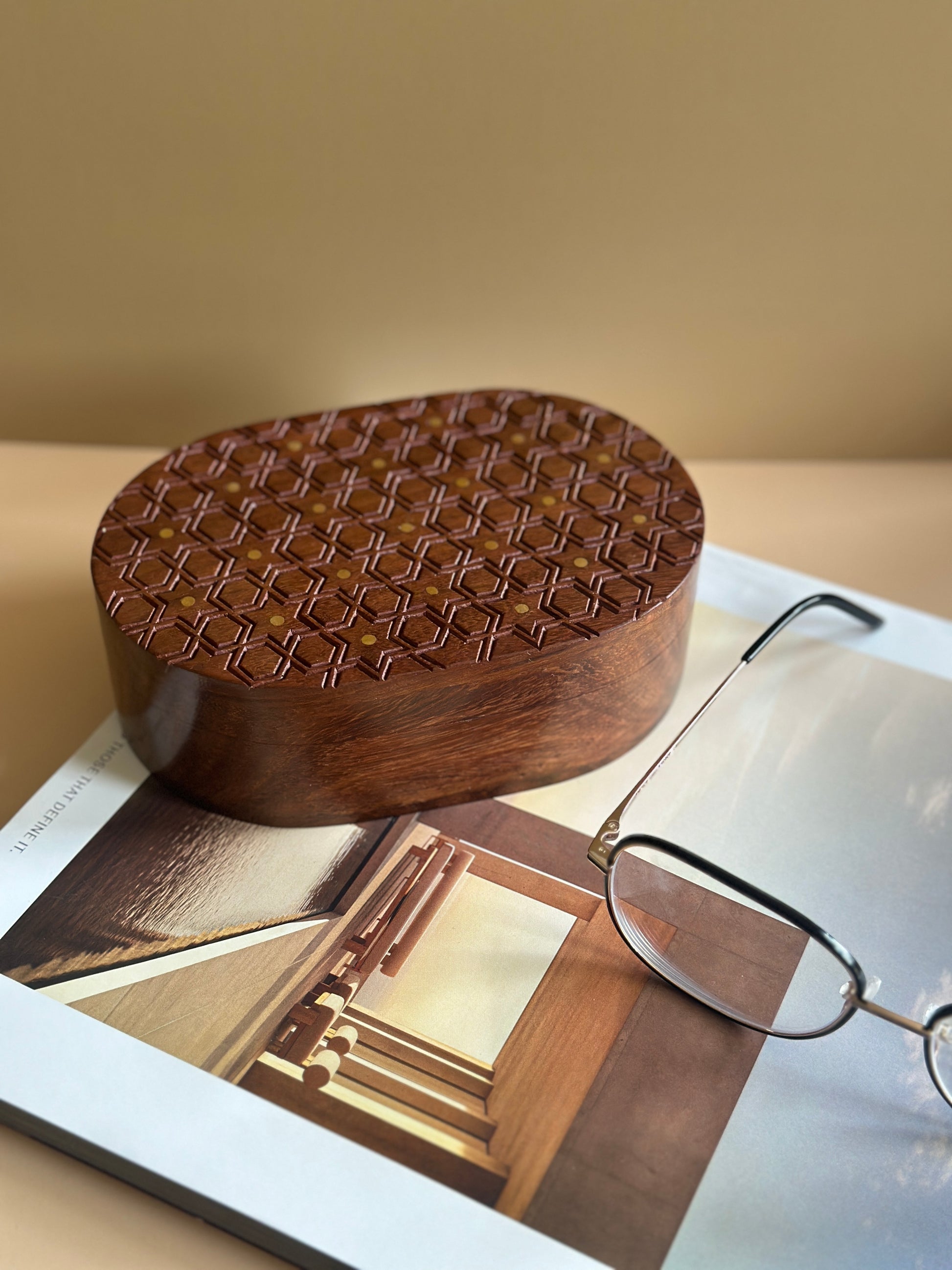 wooden decorative box with hand carving in star motifs kept on a magazine