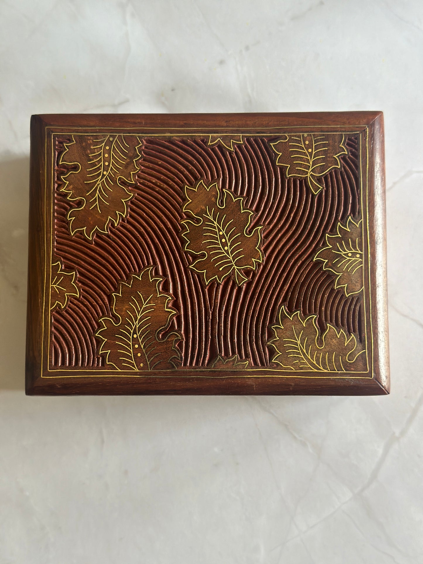 wooden carved box with gold leaf motifs