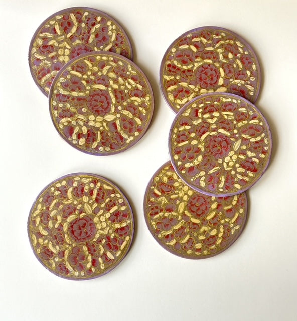 6 pink and gold hand-painted paper-mache coasters in a floral design