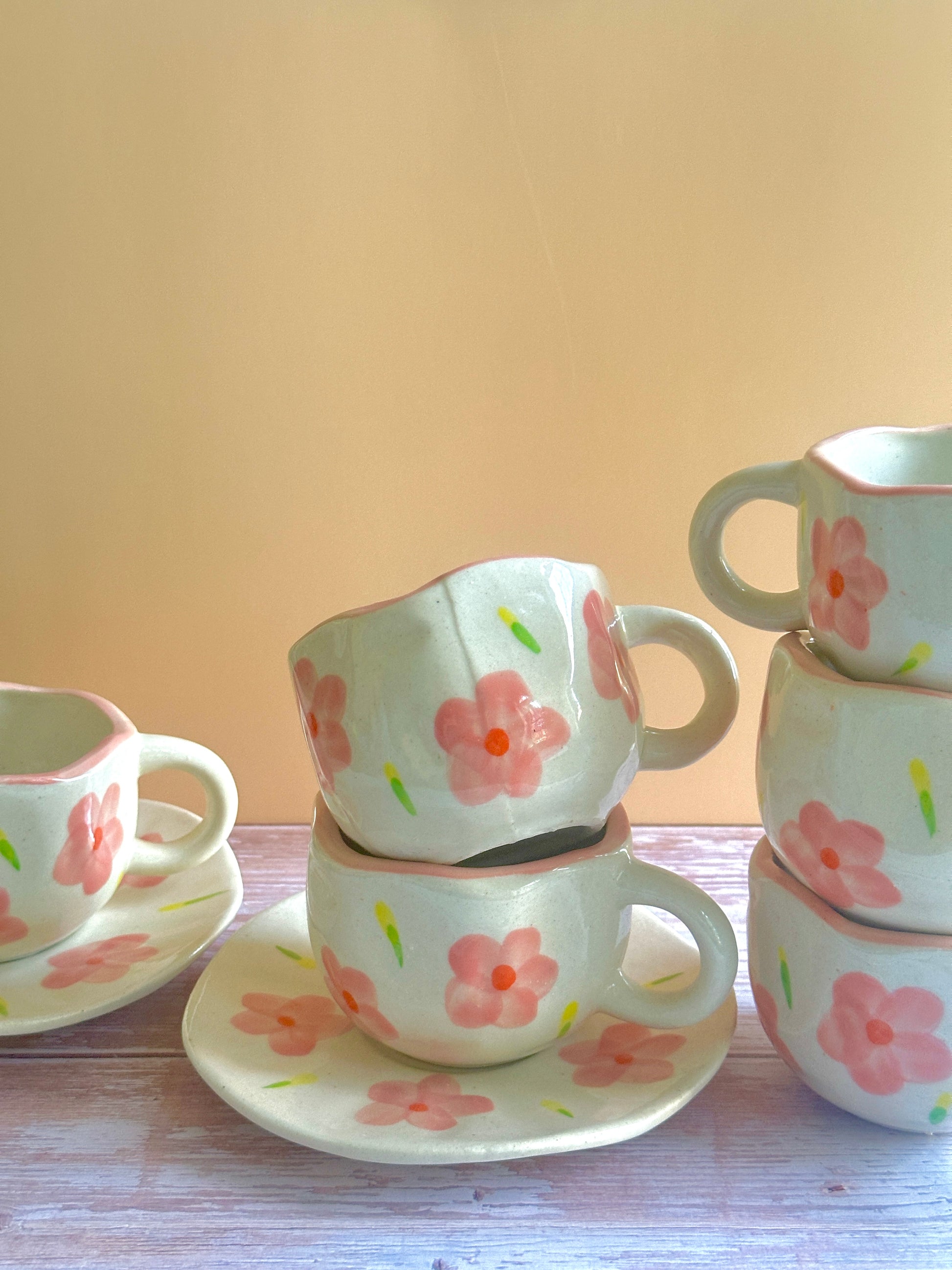 Handmade ceramic cups and saucers in a pretty white and pink floral design