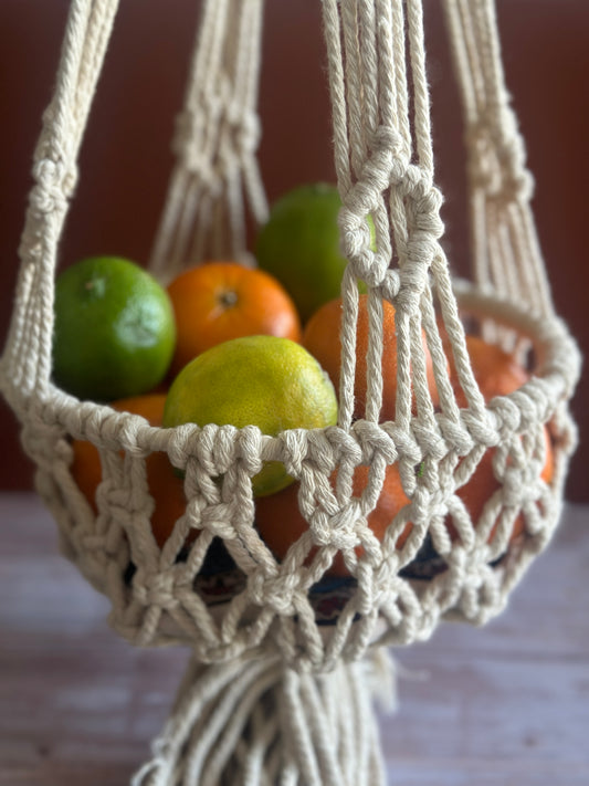 handmade macrame fruit basket containing lemons and oranges